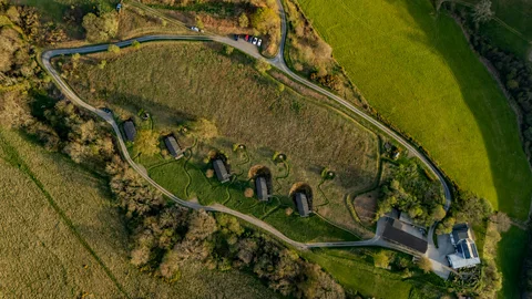 Overhead view of the Farmhouse, lake, paths and hillside lodges
