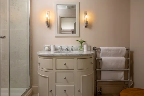 A pair of basins beneath a mirror in the Farmhouse bathroom