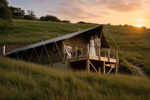 A wedding couple on a Safari Lodge deck at sunset