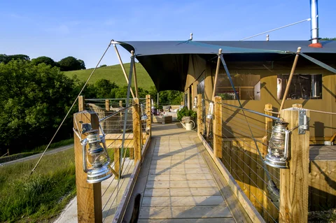 The front deck and canvas exterior of a Safari Lodge Treehouse