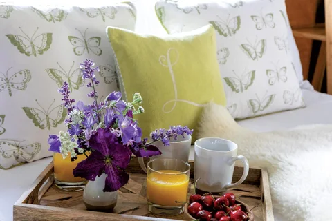 Tea, breakfast and flowers on an outdoor table