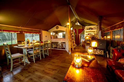 The Safari Lodge dining and sitting area lit by candles