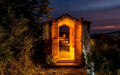 The sauna glowing with warm light in the evening