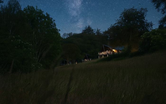 Luxury safari lodge glowing at night in Devon countryside dark sky reserve