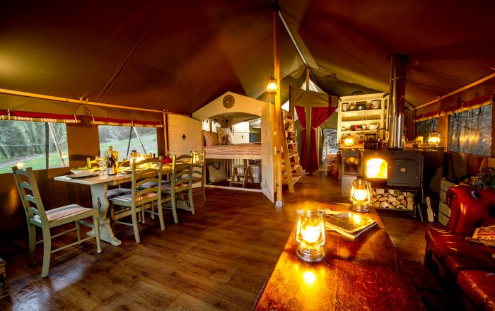 Safari lodge interior at night with cosy log burner