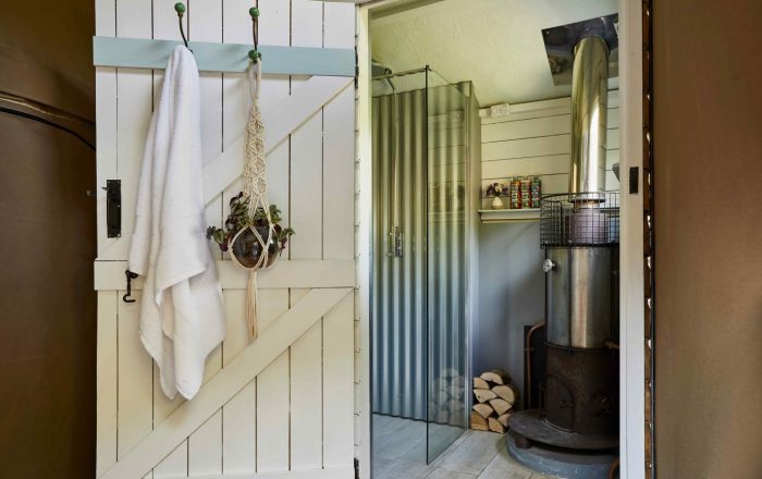 Private shower room in safari lodge at Longlands Devon with wood-fired hot water system