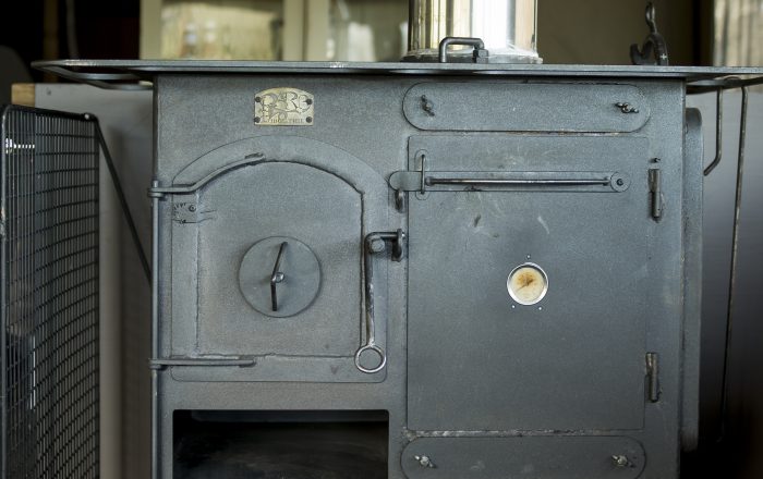 Wood-burning stove inside a luxury safari lodge at Longlands Devon providing heating and cooking