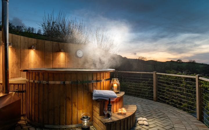 Private hot tub experience North Devon at sunset under open sky